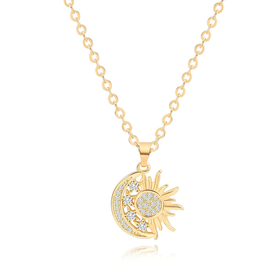 Gold necklace with sun and moon pendant on a white background