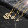 Gold necklaces with dollar sign pendants sign pendants on a dark marble surface