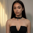 Woman wearing a black top and choker with a bow pendant against a neutral background