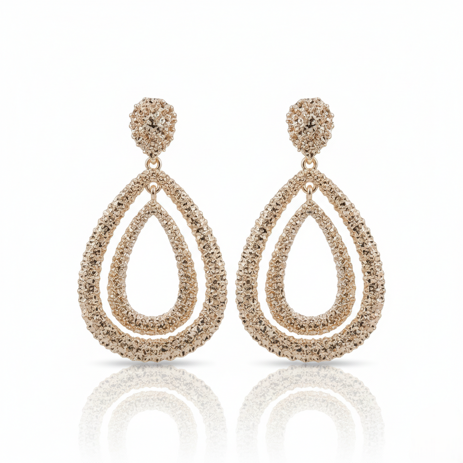 Pair of Gold-plated, double teardrop dangle earrings with a textured, rhinestone-encrusted finish. on a white background