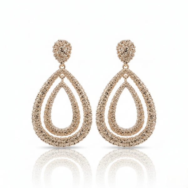 Pair of Gold-plated, double teardrop dangle earrings with a textured, rhinestone-encrusted finish. on a white background
