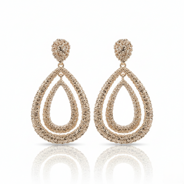 Pair of Gold-plated, double teardrop dangle earrings with a textured, rhinestone-encrusted finish. on a white background