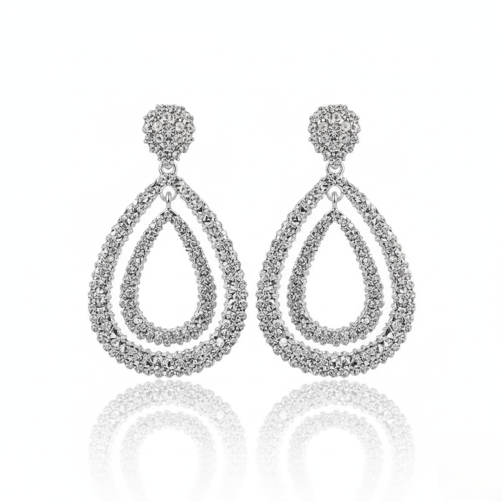 Pair of silver-plated, double teardrop dangle earrings with a textured, rhinestone-encrusted finish. 