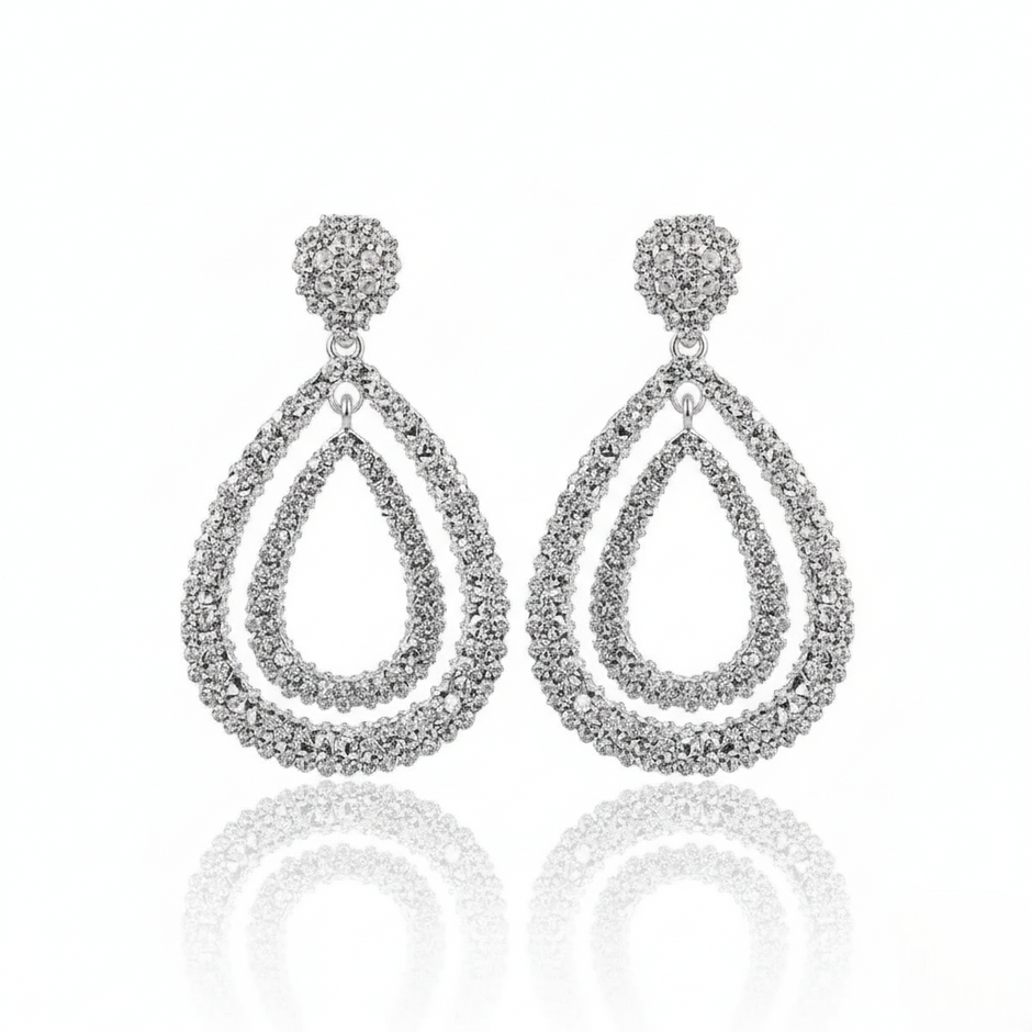 Pair of silver-plated, double teardrop dangle earrings with a textured, rhinestone-encrusted finish. 