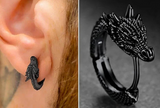 Black dragon-shaped earring worn on an ear, with a close-up of the earring on a gray background.