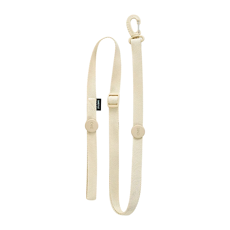 Beige dog leash with a metal clasp on a white background