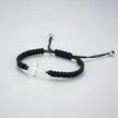 Black braided bracelet with a silver cross charm on a light gray background