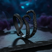 Black octopus tentacle ring on a dark background