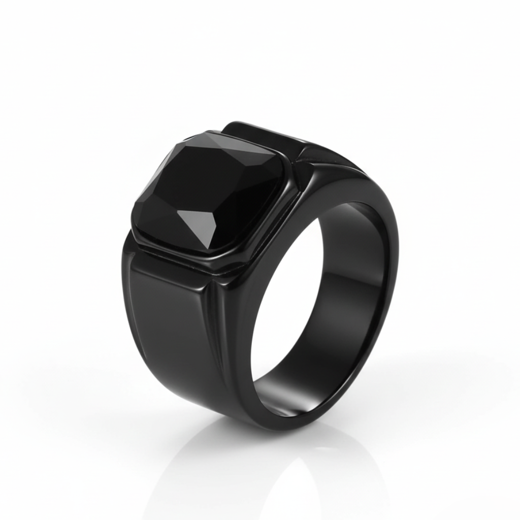 Black ring with a prominent central stone on a white background