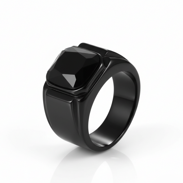 Black ring with a prominent central stone on a white background