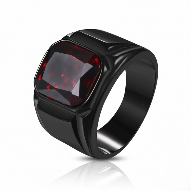 Black ring with a red gemstone on a white background