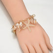 Bracelet with starfish and shell designs on a hand against a white background