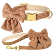 Brown dog collar and leash set with large bows on a white background