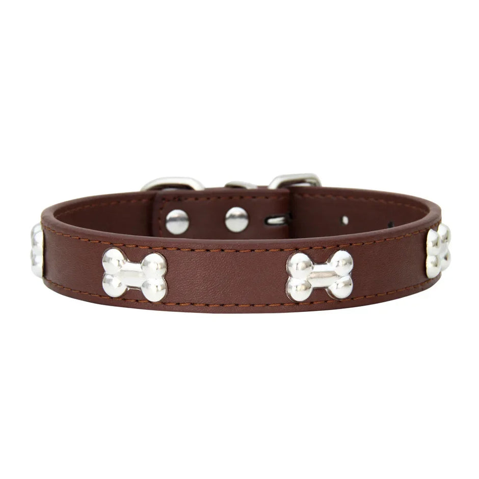 Brown leather dog collar with silver bone-shaped studs on a white background