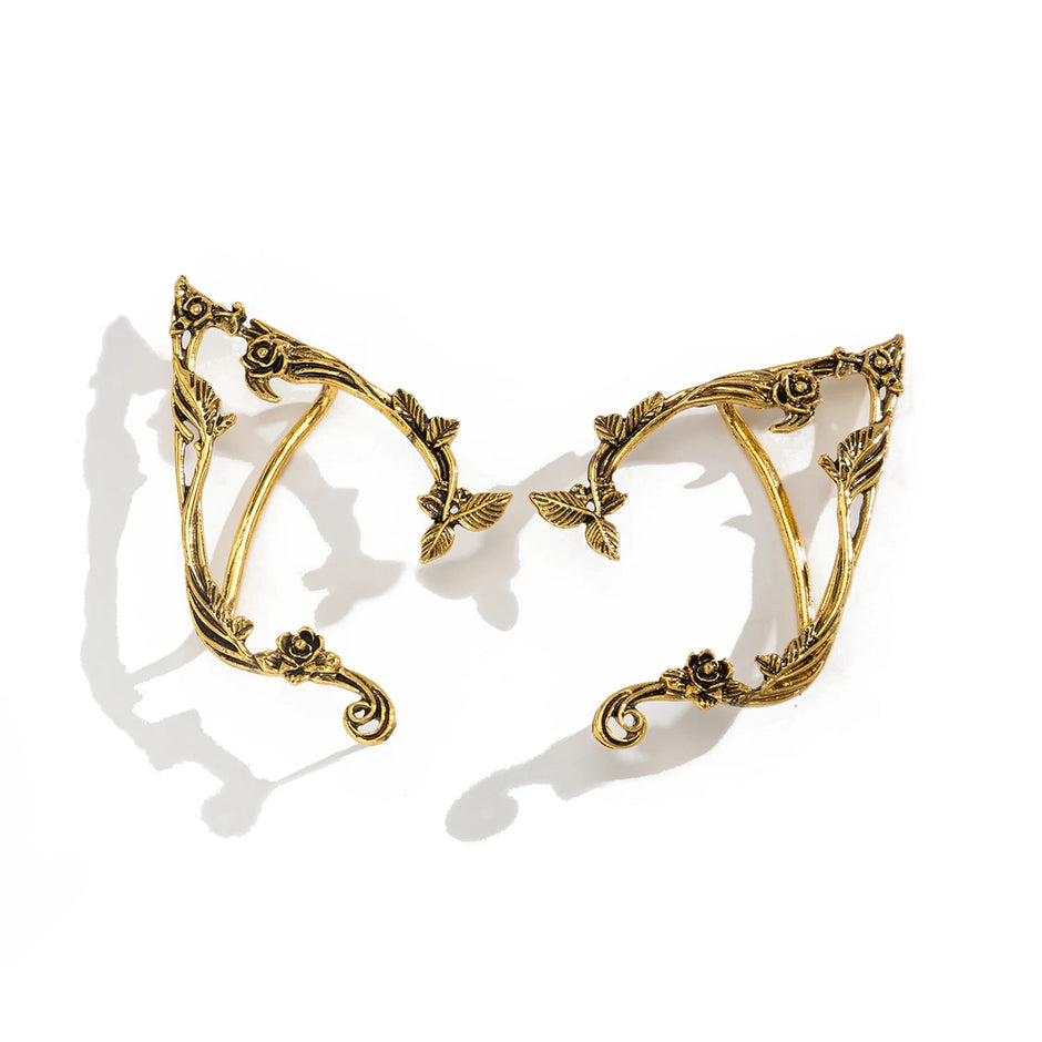 Gold leaf-shaped earrings on a white background