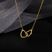 Close-up of interlocking hearts pendant necklace showing two intertwined hearts in titanium steel with high-polish finish. Romantic love jewelry design.