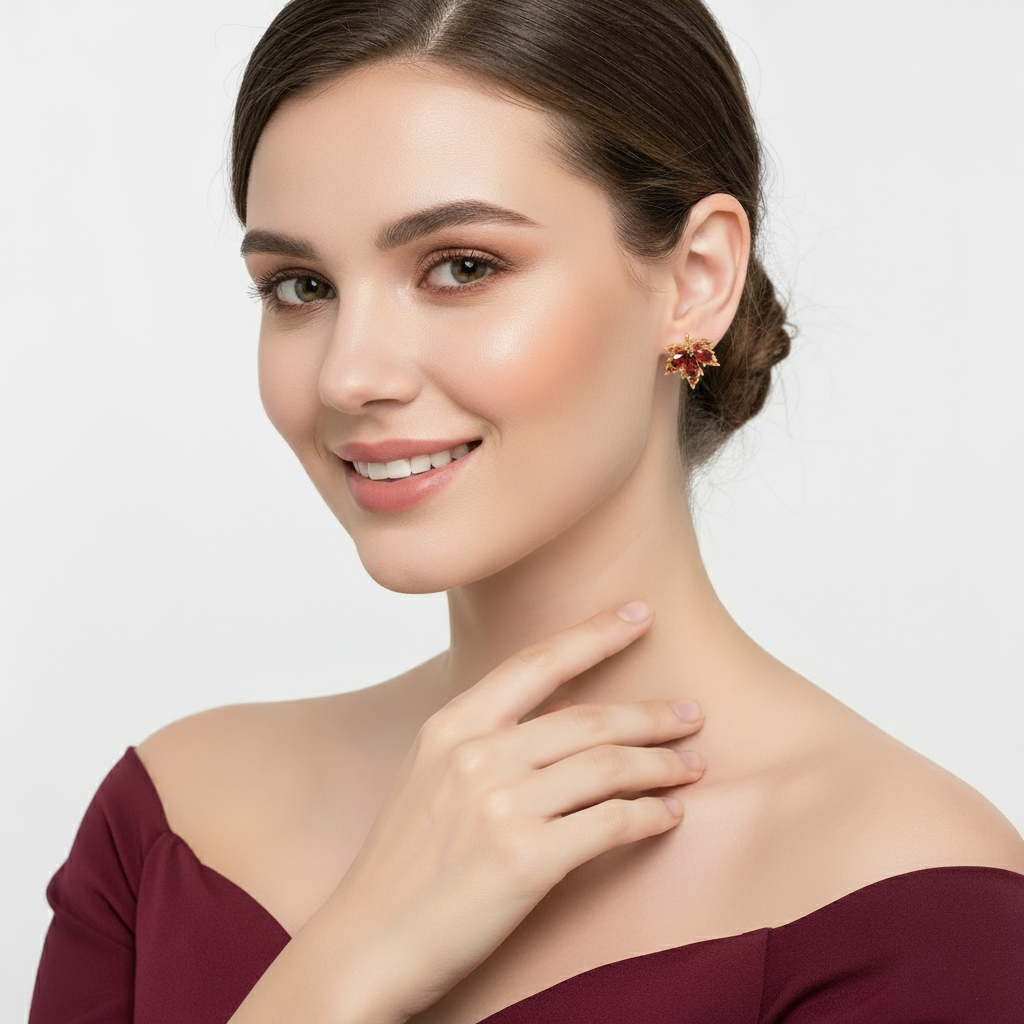 A Woman wearing a pair of Crimson Whisper – Maple Leaf Crystal Studs on a plain background