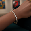 Silver-plated bracelet with AAA+ cubic zirconia on a wrist with a blurred background