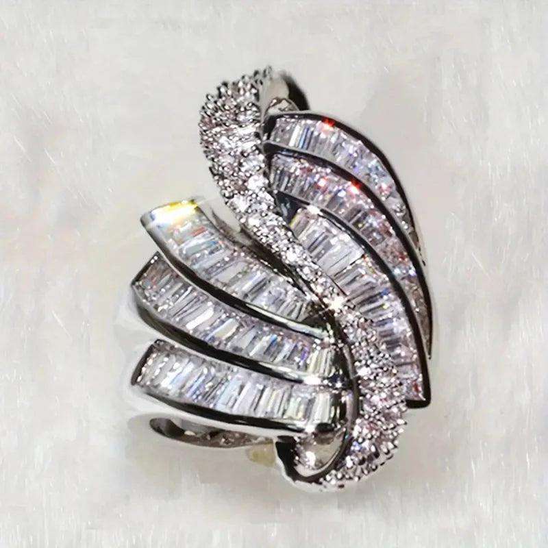 Diamond ring with multiple prongs on a white background