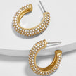 Gold hoop earrings with clear gemstones on a light gray background