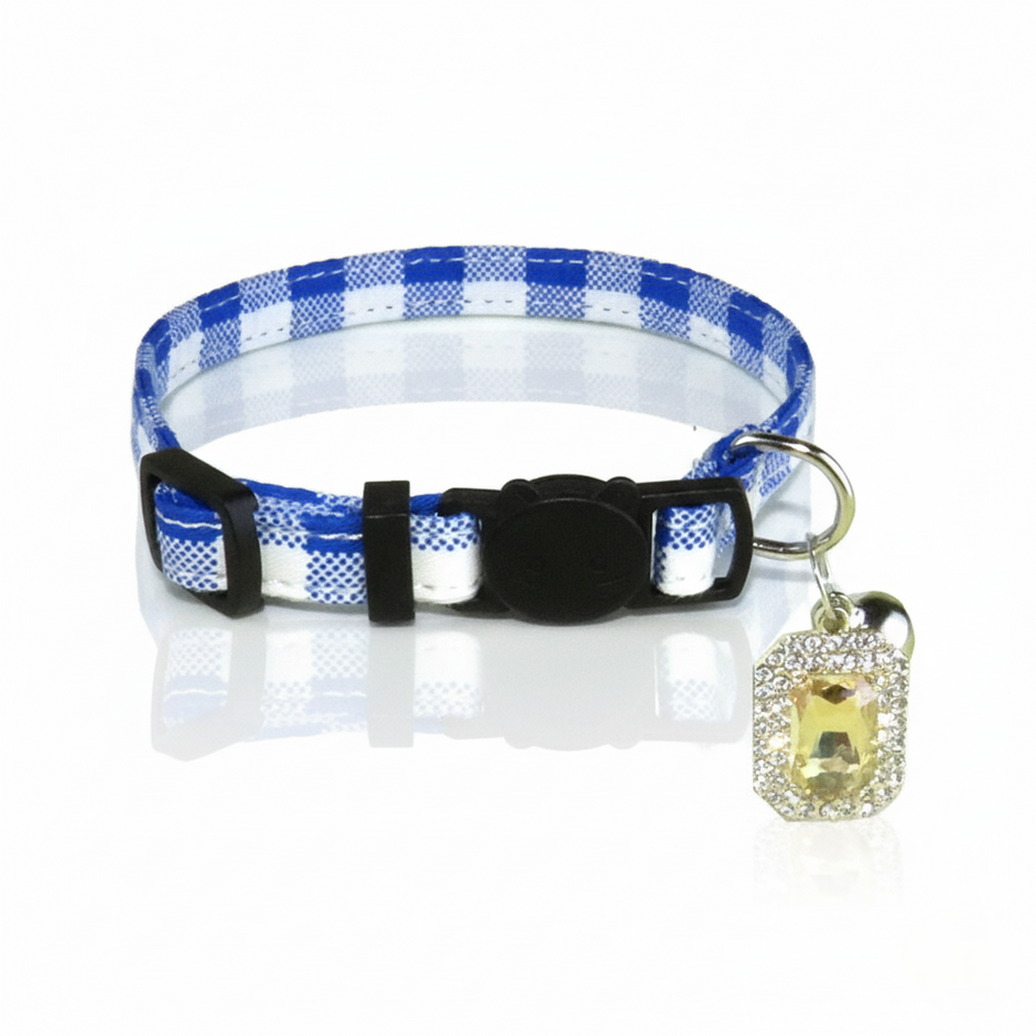 Dog collar with blue and white checkered pattern and decorative charm on a white background
