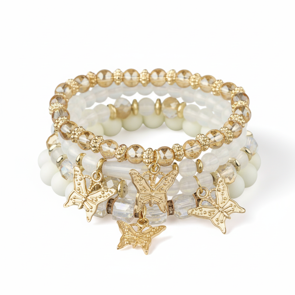 Set of beaded bracelets with butterfly charms on a white background
