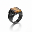 Black ring with a square tiger's eye stone on a white background