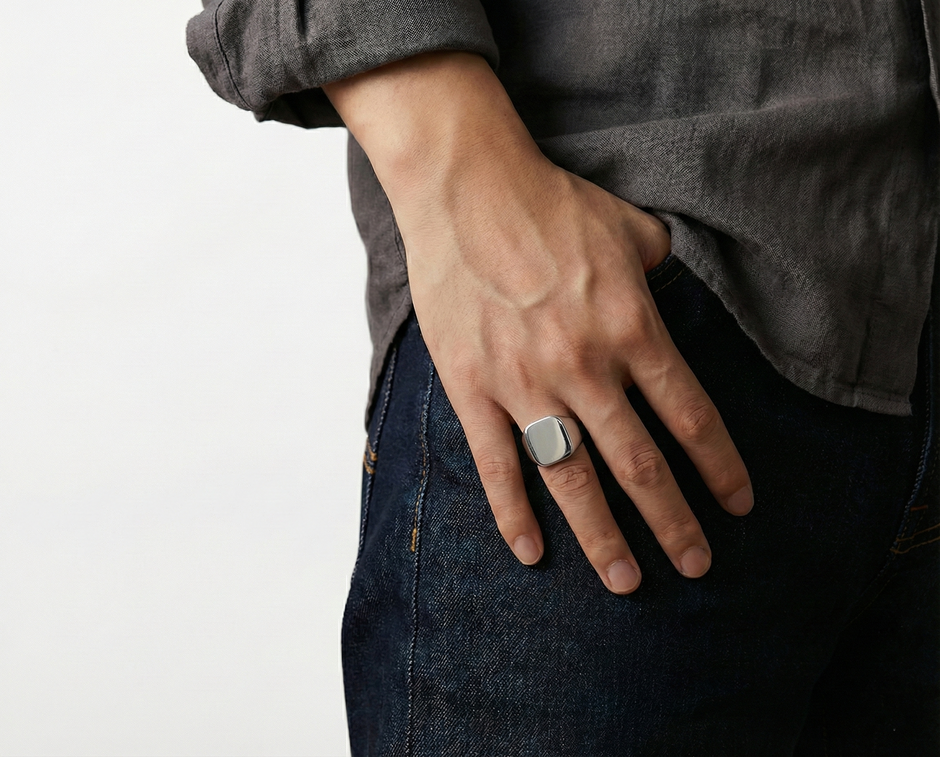 Gentle man wearing a SteelForce Silver Ring for men - 316L stainless steel band on a plain background
