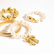 Gold and pearl bracelets on a white background