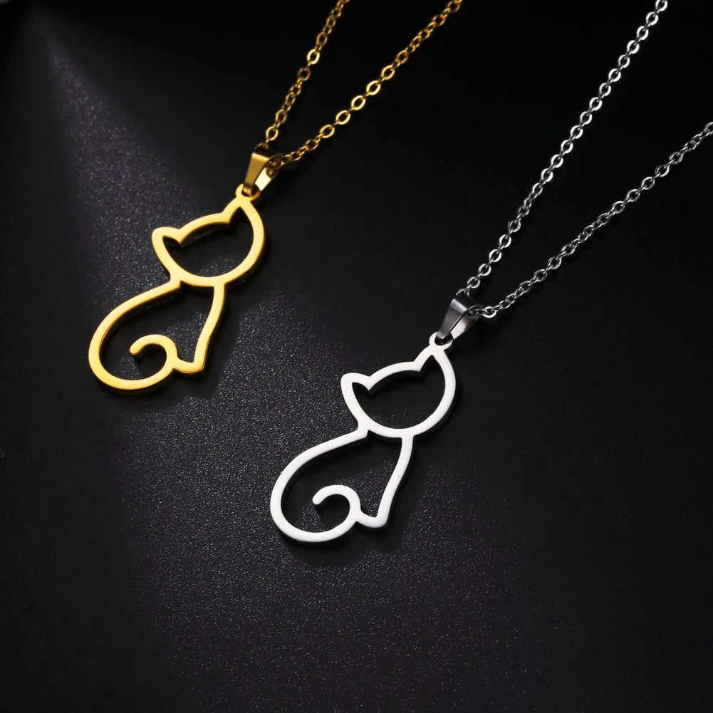 Gold and silver cat-shaped pendants on black background