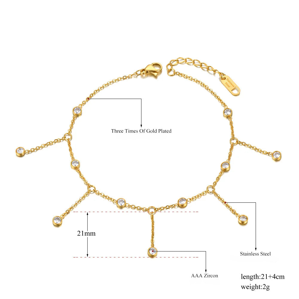 Gold anklet with small beads with clear stones on a white background