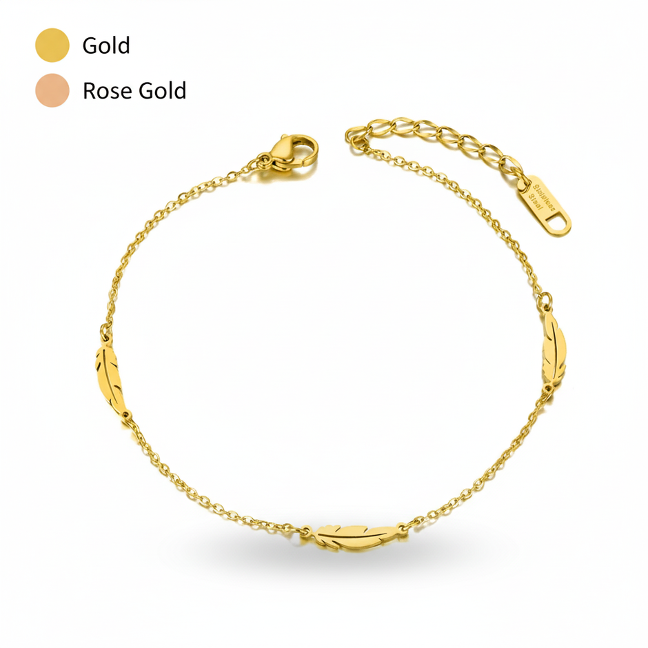 Gold anklet with a feather design on a white background