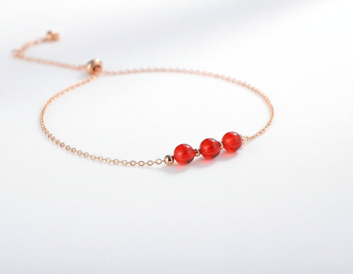 Anklet with red beads on a white background