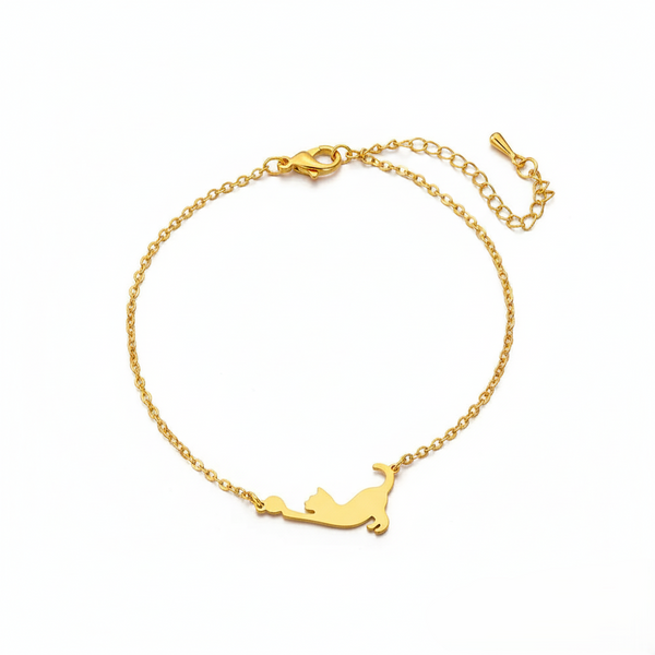 Gold bracelet with a cat-shaped pendant on a white background