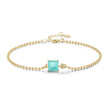 Gold bracelet with a turquoise gemstone on a white background