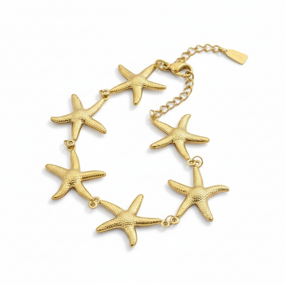 Gold bracelet with starfish charms on a white background