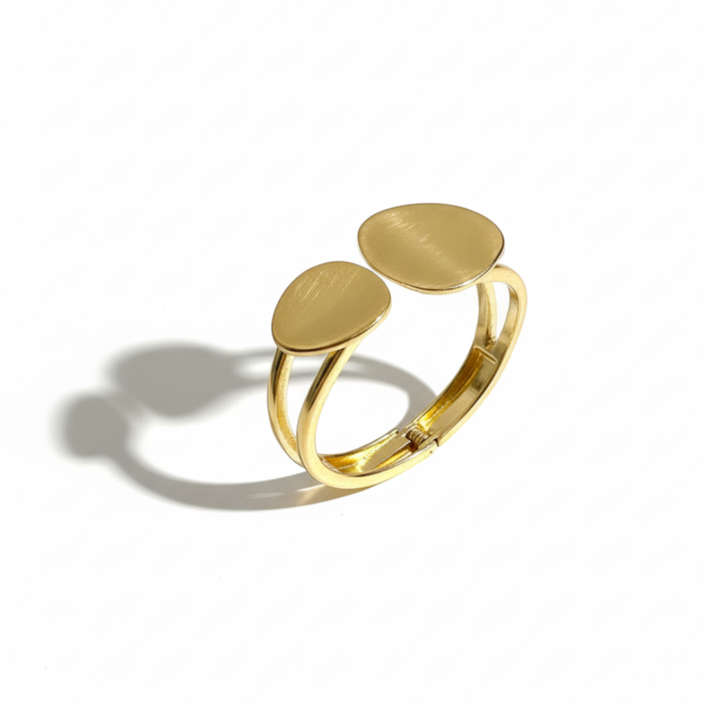 Gold bangle with two oval links on a white background