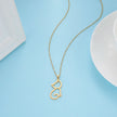 Gold cat-shaped pendant necklace on a light blue background