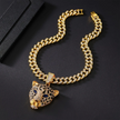 Gold chain bracelet with a leopard head pendant on a black background
