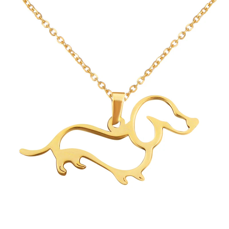 Gold dachshund-shaped pendant on a gold chain against a white background