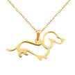Gold dachshund-shaped pendant on a gold chain against a white background