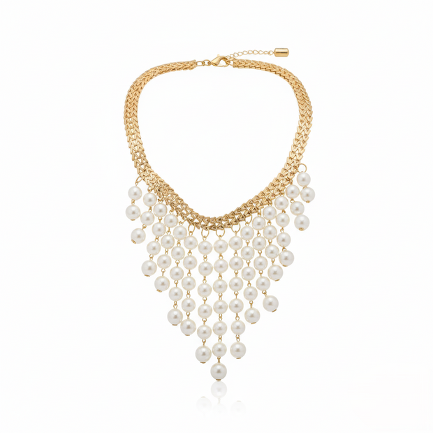 Gold necklace with pearl fringe on a white background