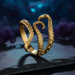 Gold octopus-shaped ring on a dark surface with a blurred underwater background