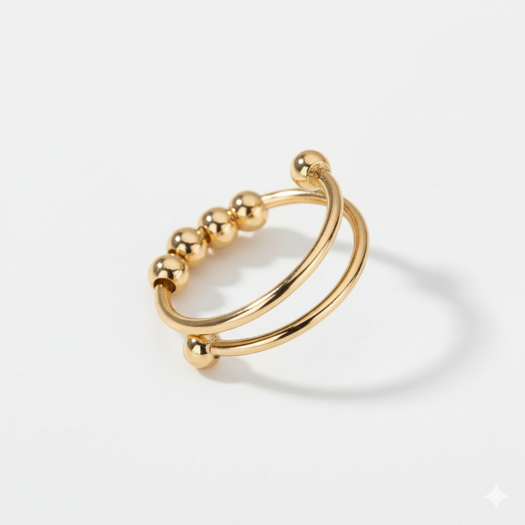 Gold ring with spherical beads on a white background