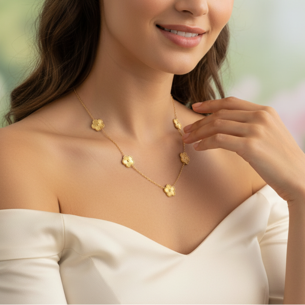 A woman wearing a gold necklace with multiple golden clover-shaped links.
