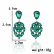 Green teardrop earrings with measurements on a white background