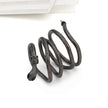 Coiled black snake-shaped object on a white background