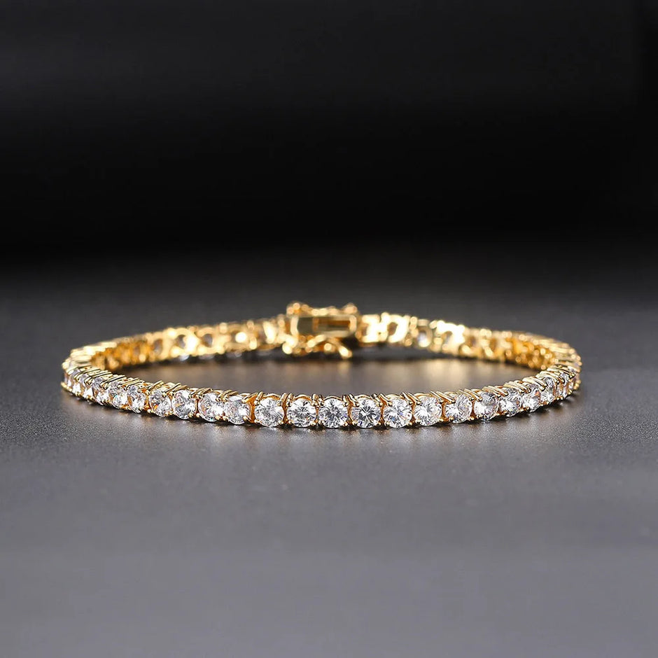 Gold bracelet with clear stones on a dark background