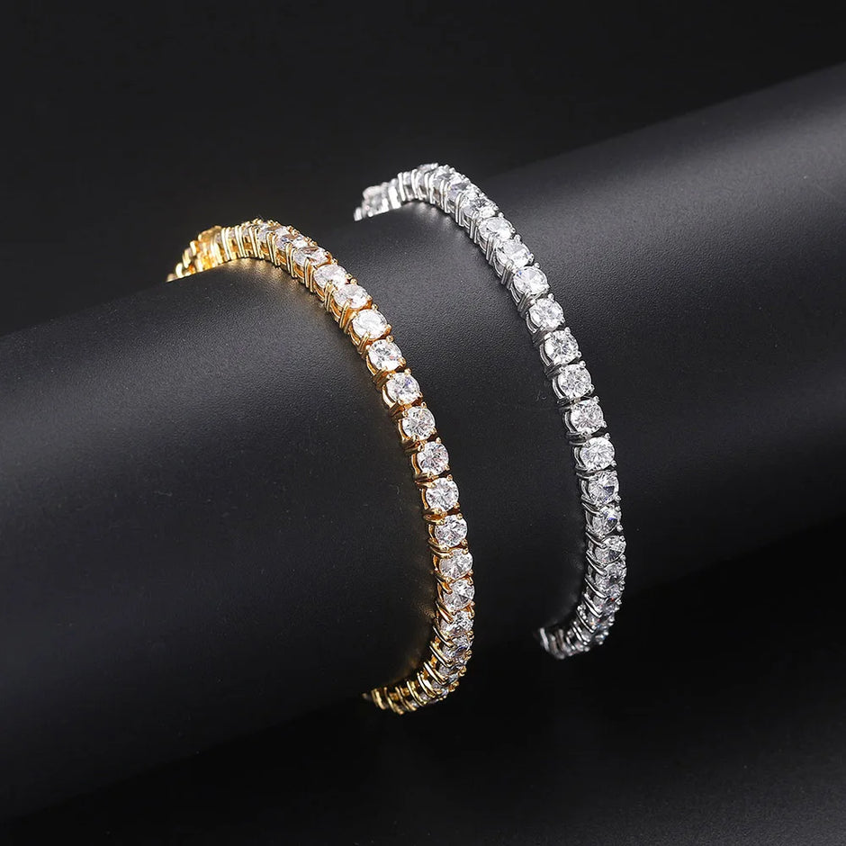 Two diamond bracelets, one gold and one silver, on a black background