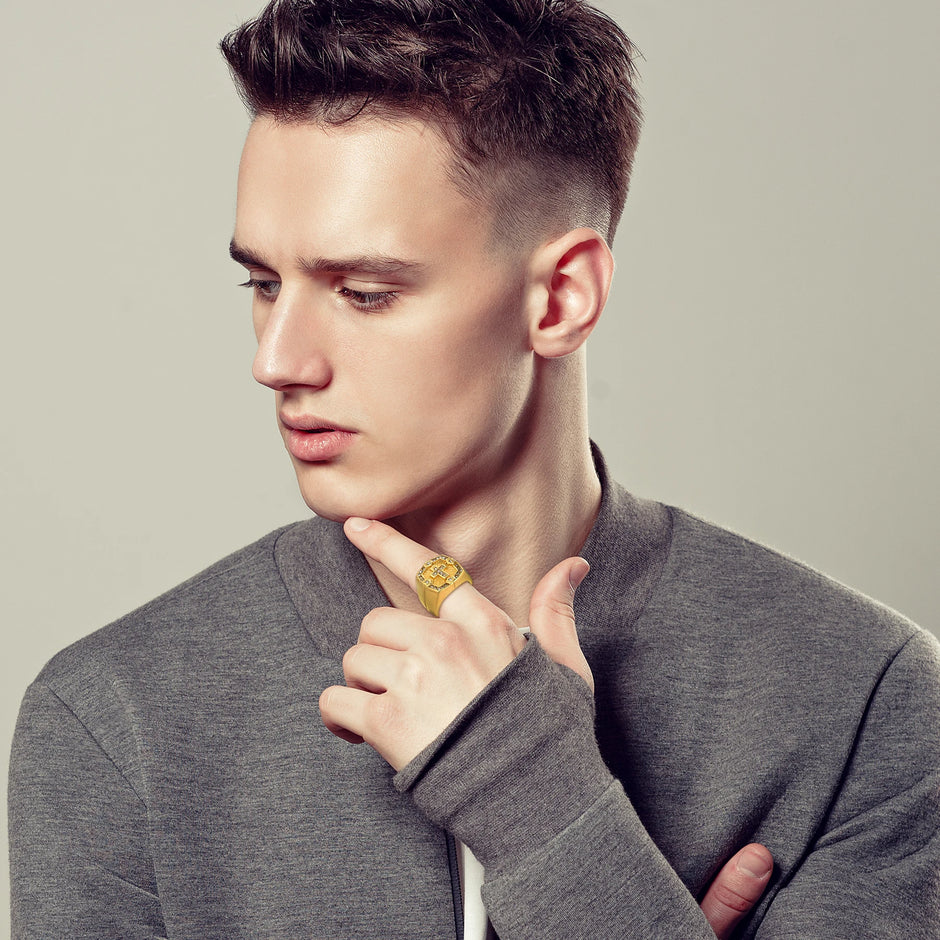 Man wearing a gray sweater with a neutral background